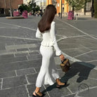 Woman in elegant classic dress and white knitwear with handbag