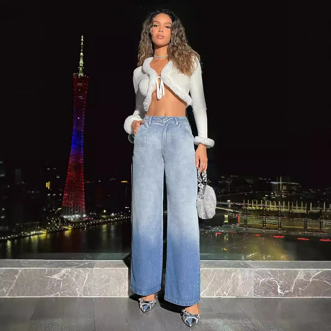 Fashionable woman wearing white cropped top with fur trim and high waist denim trousers