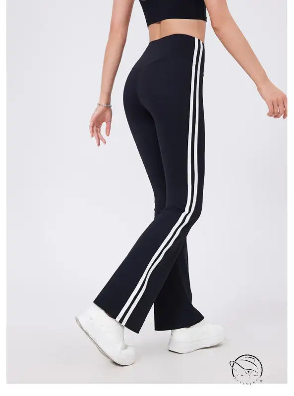 Black high waist yoga pants with white stripes and peach hip raise