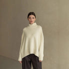 Cream oversized turtleneck Langry fashion sweater with black pants