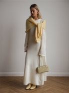 Cream textured knitted cardigan sleeveless dress with yellow scarf and beige handbag
