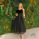 Elegant black feather-trimmed tulle evening dress in Langry fashion