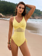 Yellow one-piece mesh swimsuit showcasing cross-over design, ideal for fashionistas and summer wear