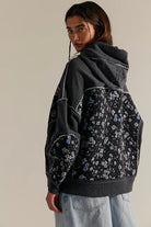 Black floral langry hooded embroidery sweater with gray sleeves and denim jeans