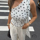 Polka dot one-shoulder tank top with asymmetrical hem in black and white