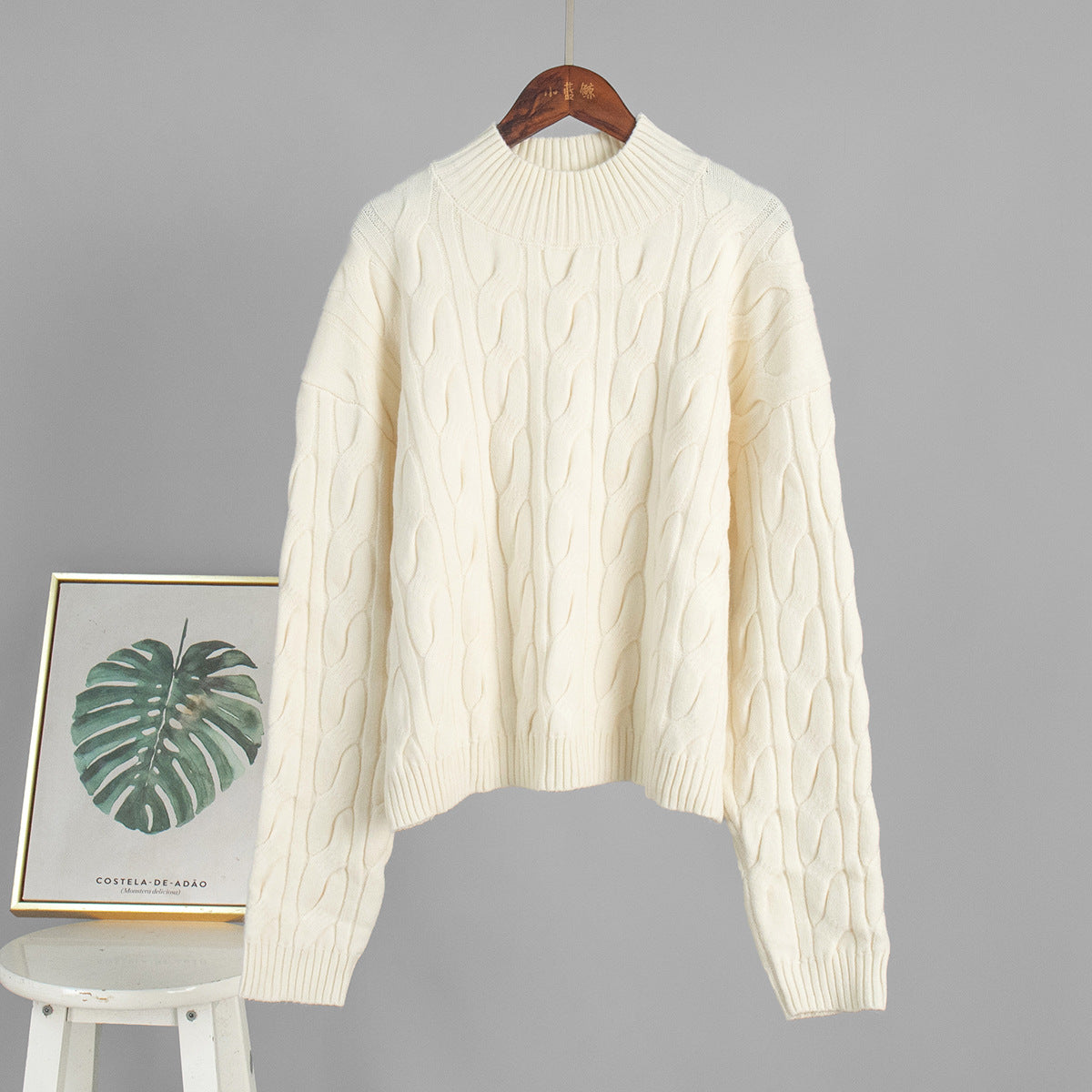 Cream cable knit sweater on wooden hanger, Langry winter fashion ملابس