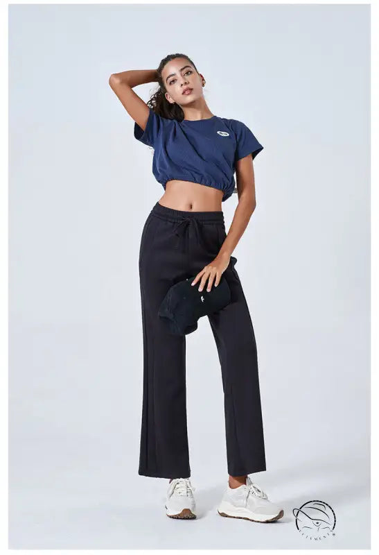 Navy blue crop top with black summer air layer wide-leg yoga pants and white sneakers