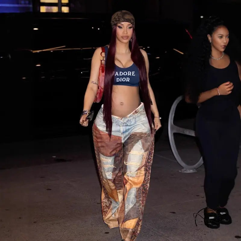 Model in J’Adore Dior crop top, casual dirty denim pants, red shoulder bag