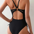 Black one-piece swimsuit with cutout back, adjustable straps, a stylish fashion choice