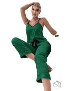 Emerald green satin pajama set with black trim and green eye mask