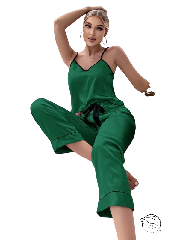 Emerald green satin pajama set with black trim and green eye mask