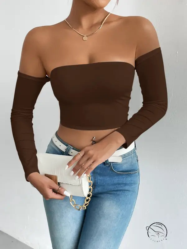 Woman in brown camisole waist trimming short sleeve crop top with jeans