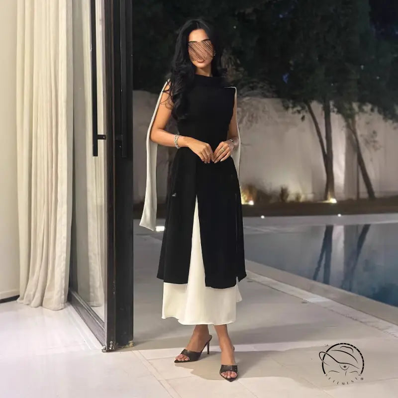 Multicolor sleeveless slim elegance retro dress with ruffled hem in black and white, high heels, silver bracelet