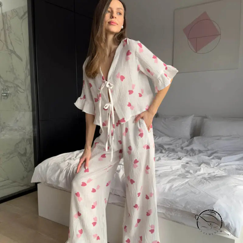 Woman in white ruffled short sleeves pajamas with pink hearts
