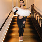 White fluffy fur stole with black trim on long sleeve fashion jumpsuit