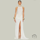 White high-split evening gown with tight waist, gold accents, and Langry jewelry