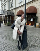 Warm winter faux fur coat in cream with black trim and oversized design