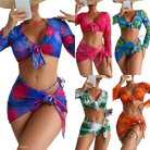 Four piece lace up swimsuit in vibrant tropical print with red flowers on blue background