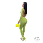 Woman in elegant backless slit jumpsuit, green fabric