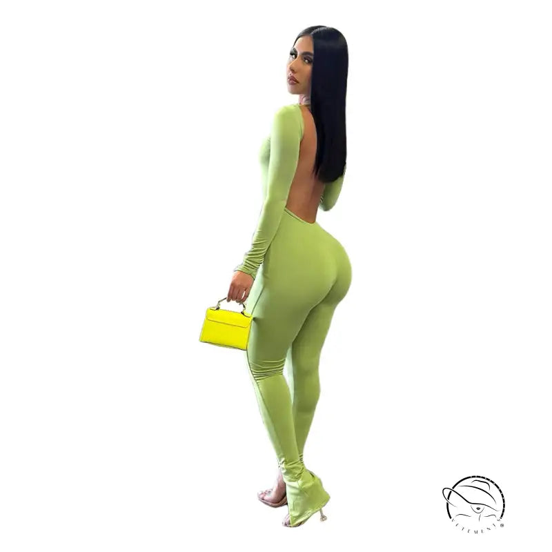 Woman in elegant backless slit jumpsuit, green fabric