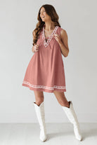 Pink sleeveless dress with white trim showcasing trendy langry fashion ملابس style