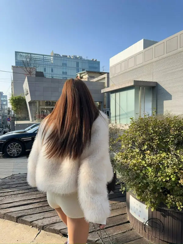 White faux fur coat with long sleeves and high collar