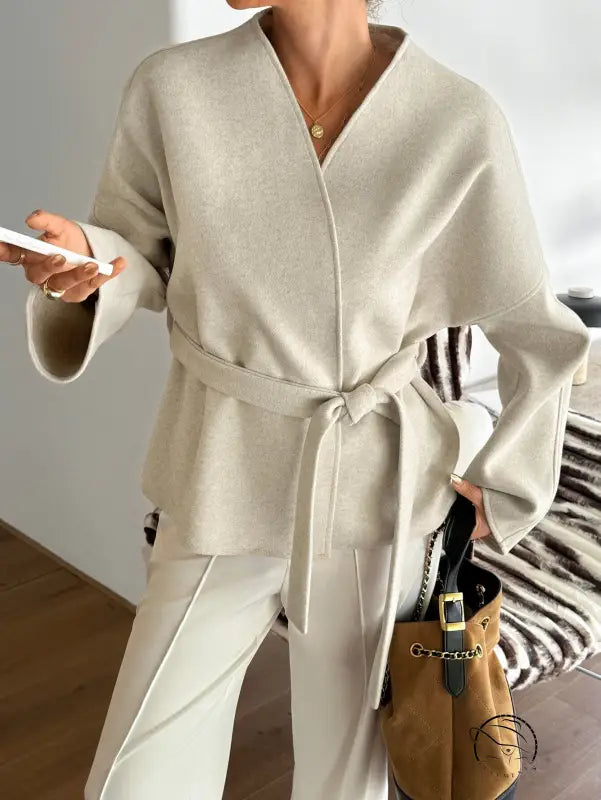 Cream-colored oversized langry fashion blazer with belt and pocket detail