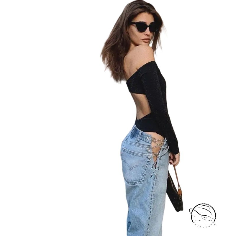 Woman in off-shoulder black top and sexy chain straight jeans