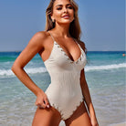 White ribbed one-piece swimsuit with lace trim, ideal for fashion-forward swimwear lovers