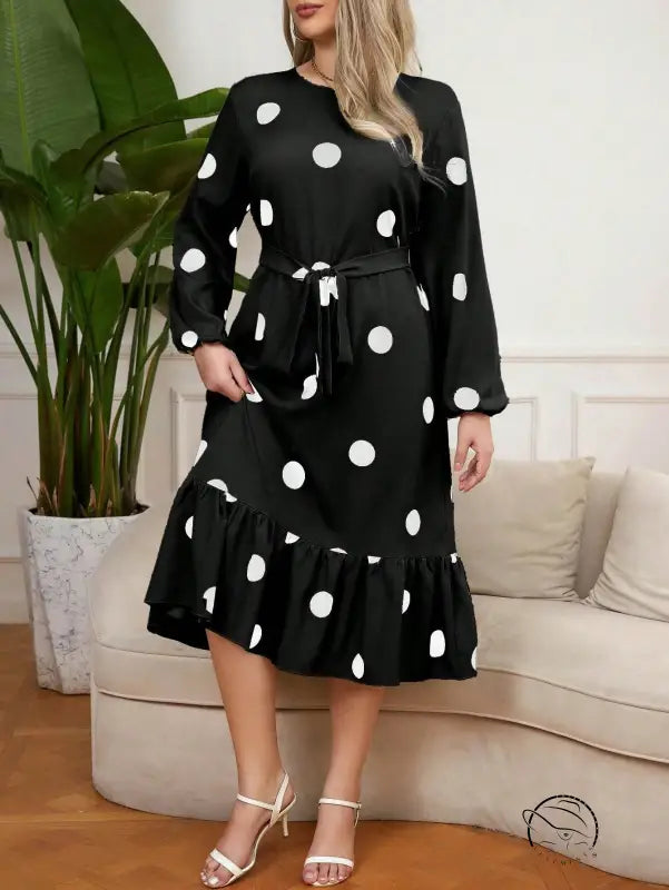 Long-sleeved black lotus leaf dress with white polka dots and ruffled hem