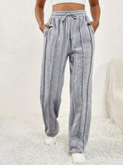 Light gray wide leg sweatpants with pinstripes and adjustable drawstring waistband