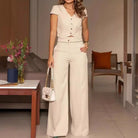 Beige two-piece pantsuit showcasing a stylish short sleeve design for modern fashion