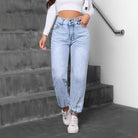 Light-wash blue match beaded straight jeans with elasticized ankles and white sneakers