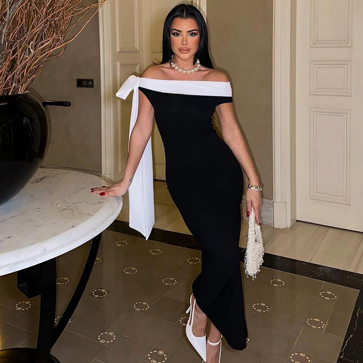 Elegant black and white off-shoulder evening gown with bow detail for stylish fashion ملابس