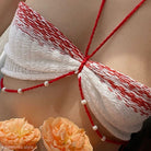 Red and white woven top with pearl accents in a sexy oversleeve knitted design