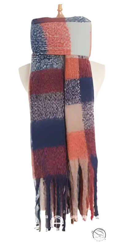 Striped winter scarf with fringe in navy blue, coral pink, and cream colors, showcasing purplish red