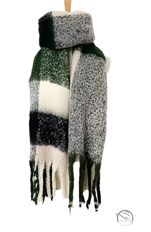 Plaid winter scarf with fringe tassels in green, white, and gray colors next to a purplish red wool stitching scarf