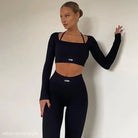 Woman in black AONR athletic crop top and high waist skinny leggings two piece set