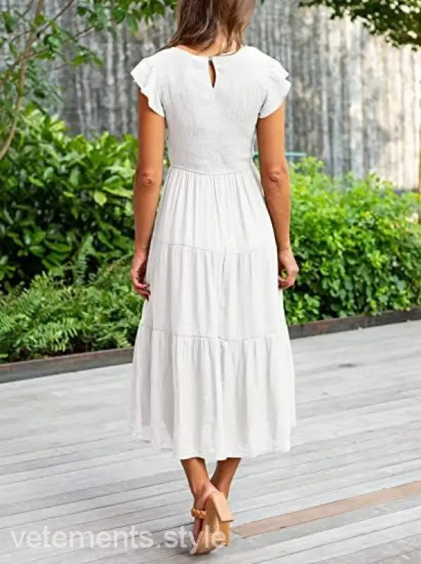 White tiered midi dress featuring flounced large swing design with ruffle and cutout details