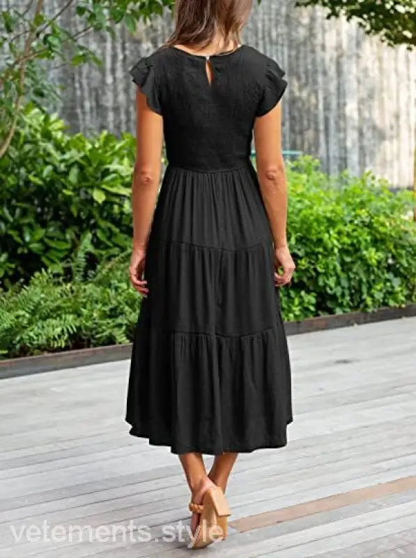 Black tiered midi dress featuring flounced large swing design with ruffle and cutout details