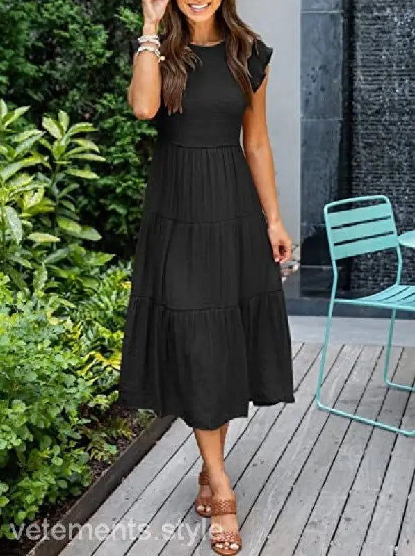 Black tiered midi dress featuring flounced large swing design with cutout details