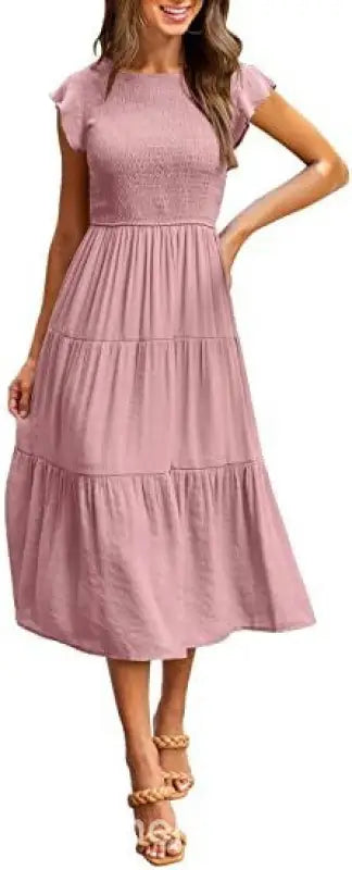 Pink tiered midi dress in a flounced large swing style with ruffle and cutout details