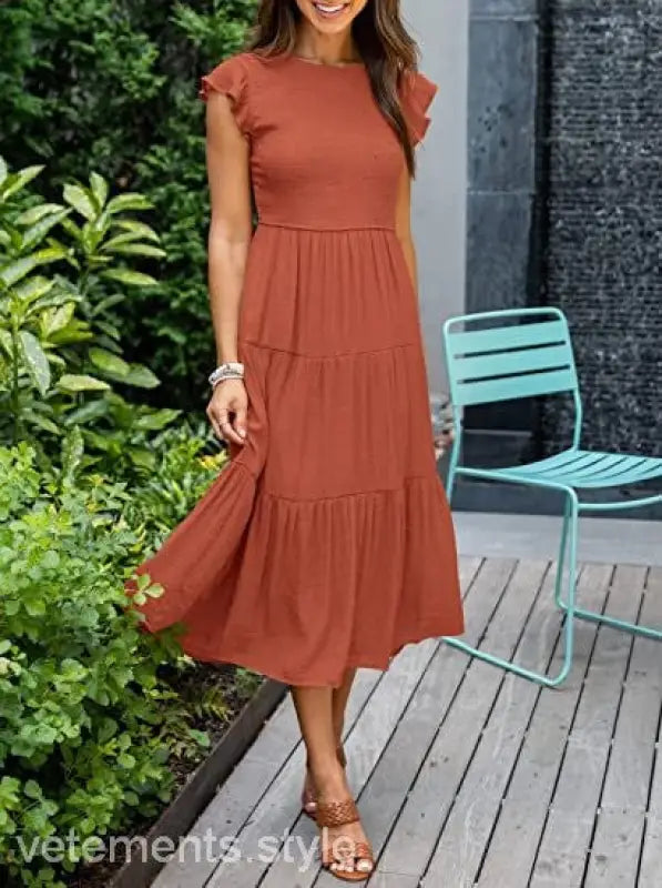 Rust-colored tiered midi dress featuring a flounced large swing silhouette with cutout details