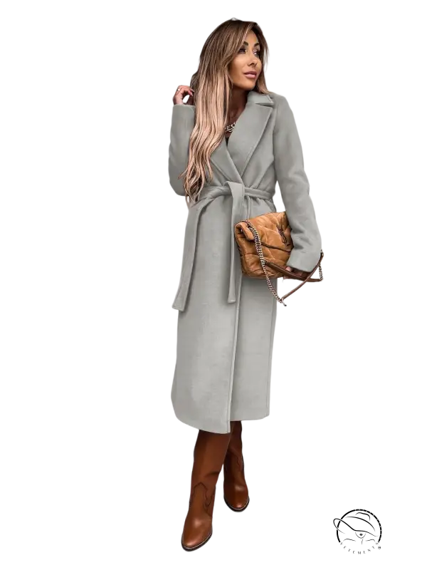 Woman in army green polo collar long sleeved belted wool coat and brown boots