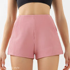 Pink ribbed high waist yoga shorts paired with a black crop top for stylish comfort