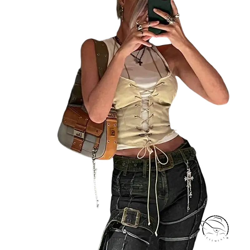 Backless bandage corset top with lace-up front over white shirt, paired with dark pants and accessories