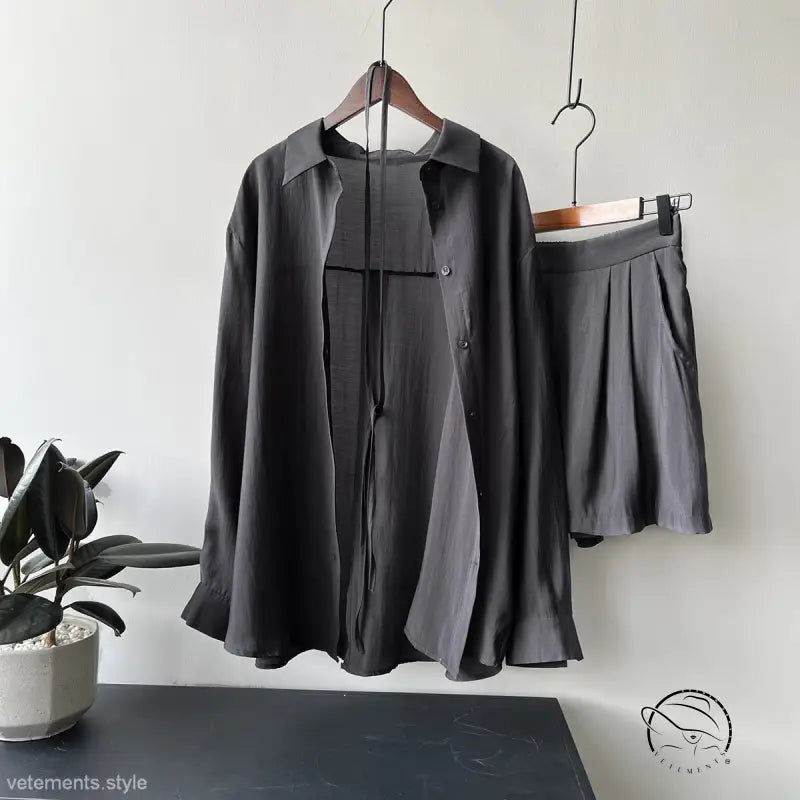 Dark gray belted sun protection shirt suit with shorts on hangers