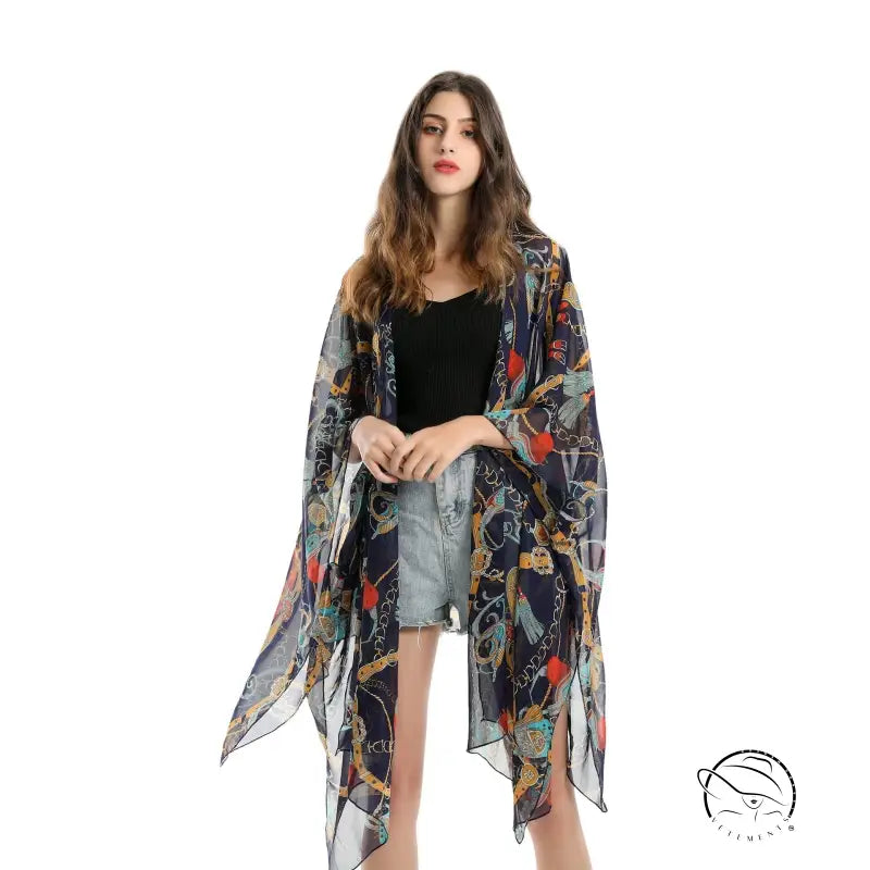 Colorful patterned chiffon swimsuit blouse light over black top and denim shorts