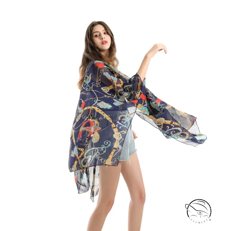 Woman in colorful patterned chiffon swimsuit blouse with wide kimono sleeves