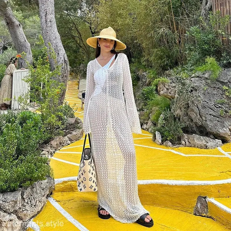 Woman in sheer white dress and straw hat, ideal summer beach dress for vacations